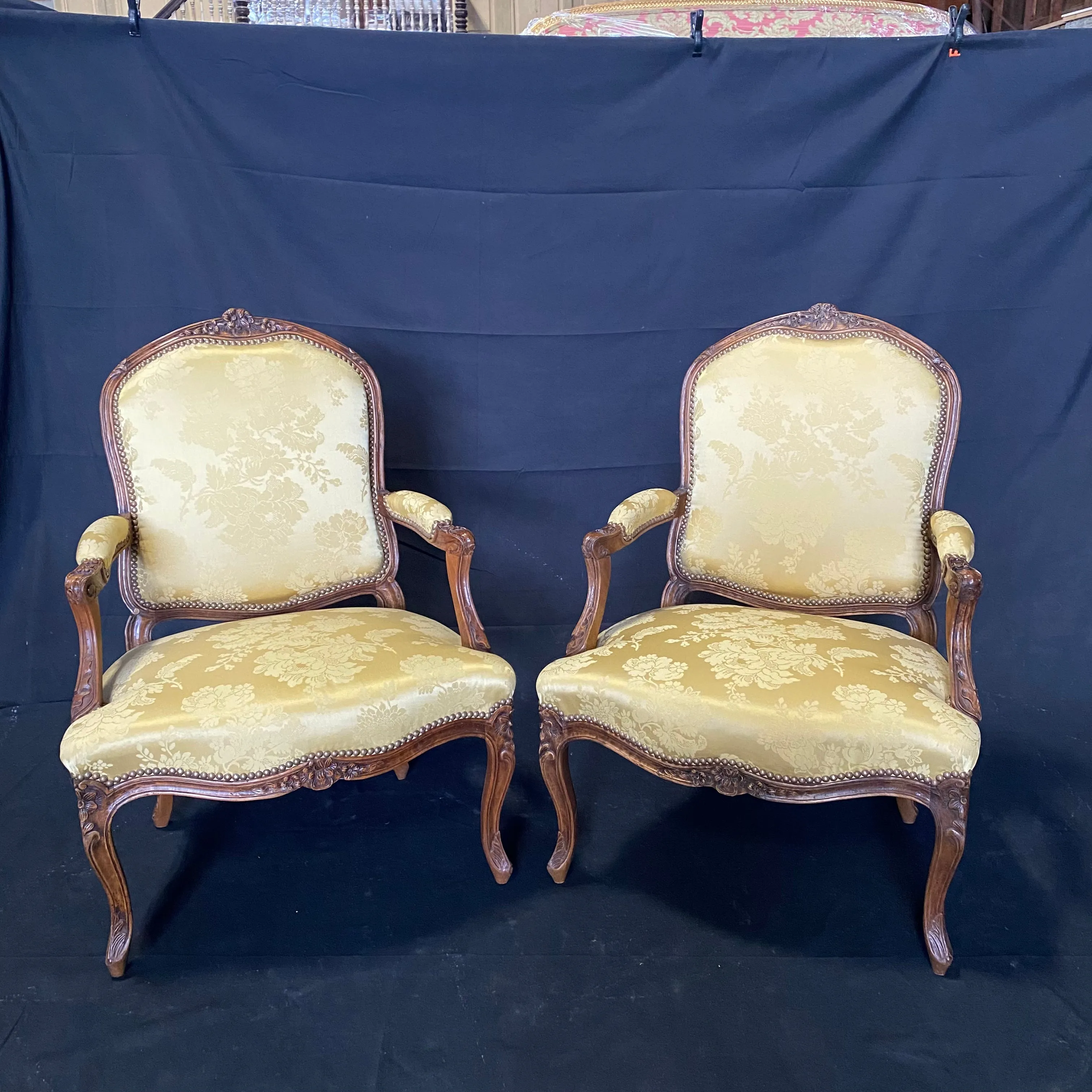 Pair of French Louis XV Walnut Carved Fauteuils or Arm Chairs with Pale Flaxen Yellow Damask and Brass Tacking