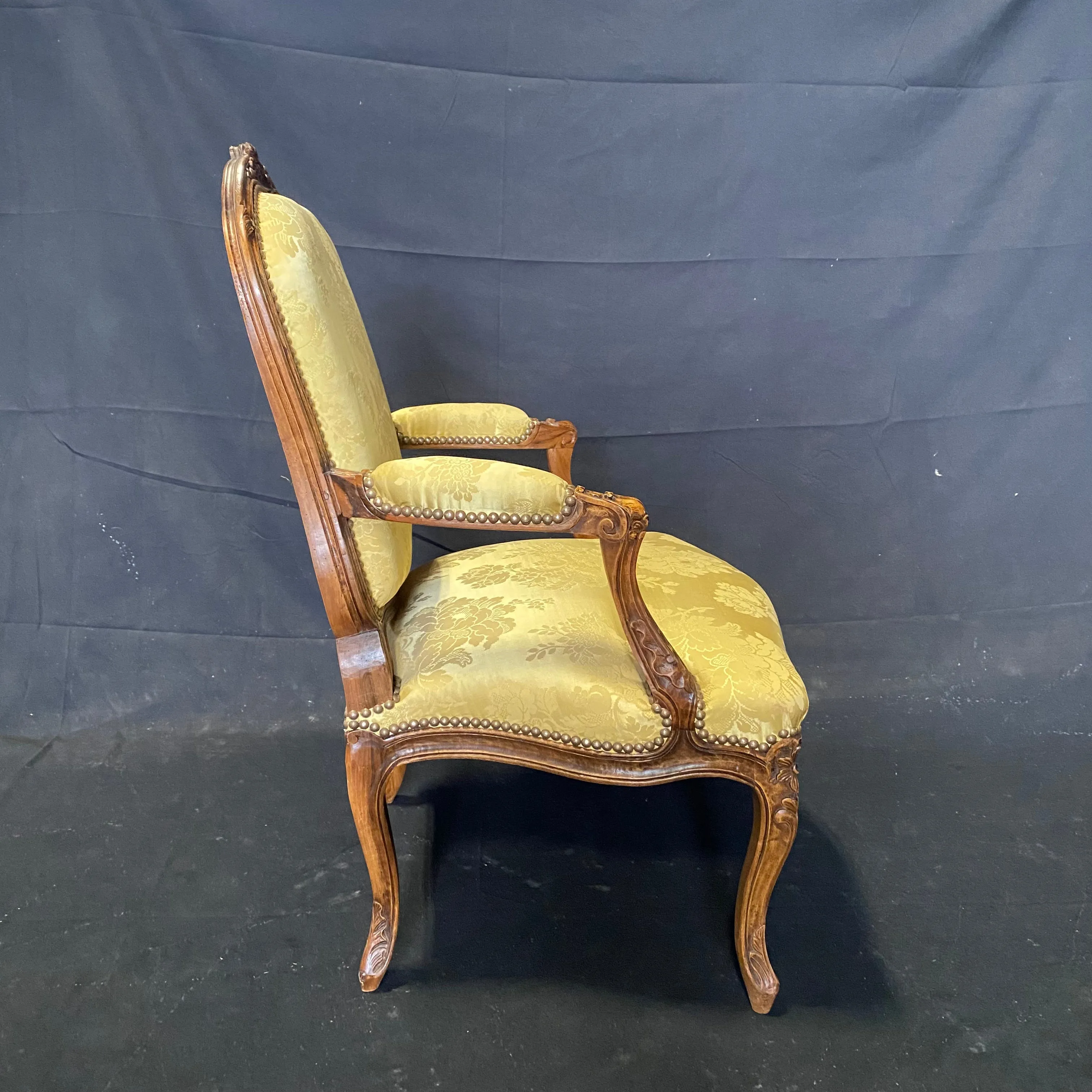 Pair of French Louis XV Walnut Carved Fauteuils or Arm Chairs with Pale Flaxen Yellow Damask and Brass Tacking