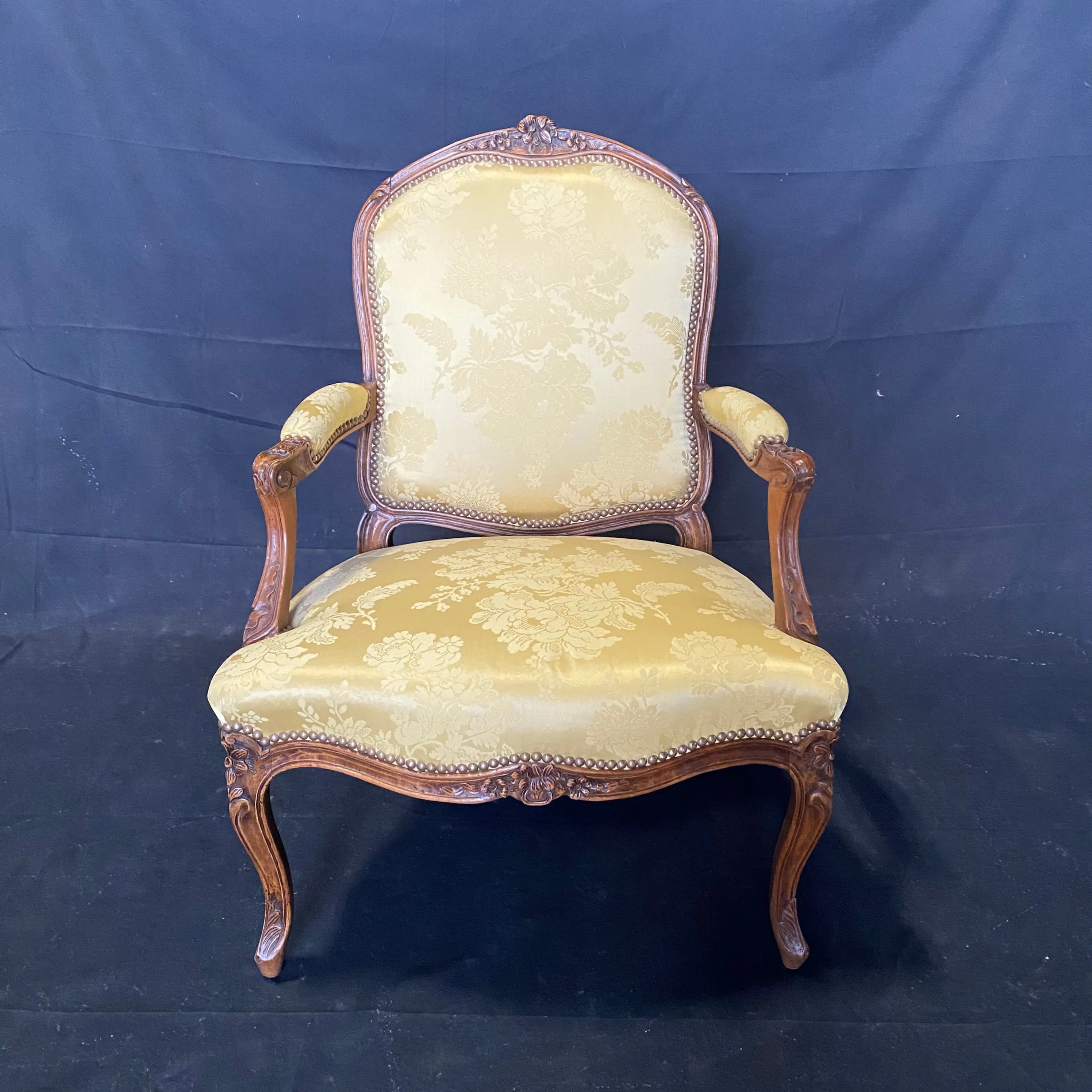 Pair of French Louis XV Walnut Carved Fauteuils or Arm Chairs with Pale Flaxen Yellow Damask and Brass Tacking