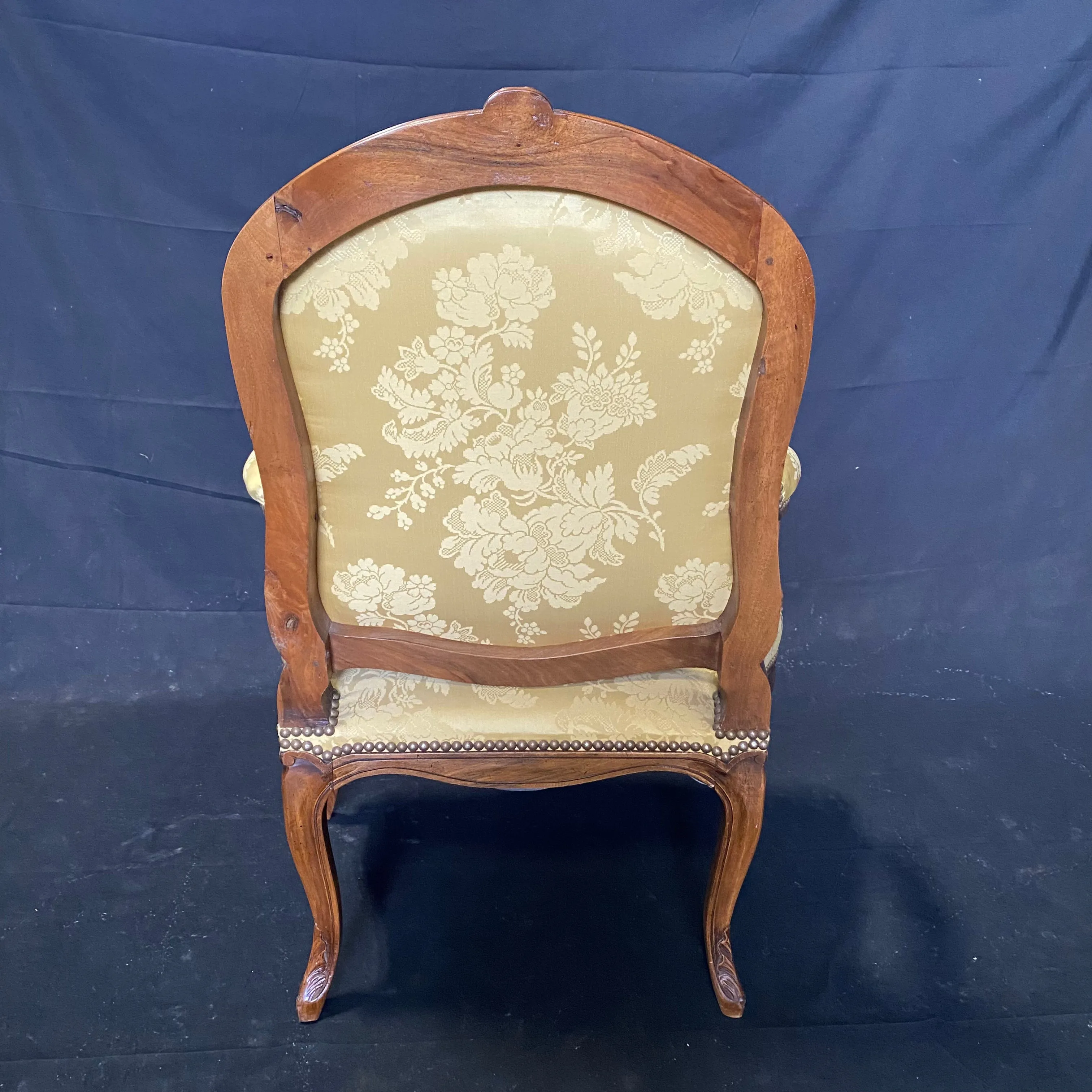 Pair of French Louis XV Walnut Carved Fauteuils or Arm Chairs with Pale Flaxen Yellow Damask and Brass Tacking