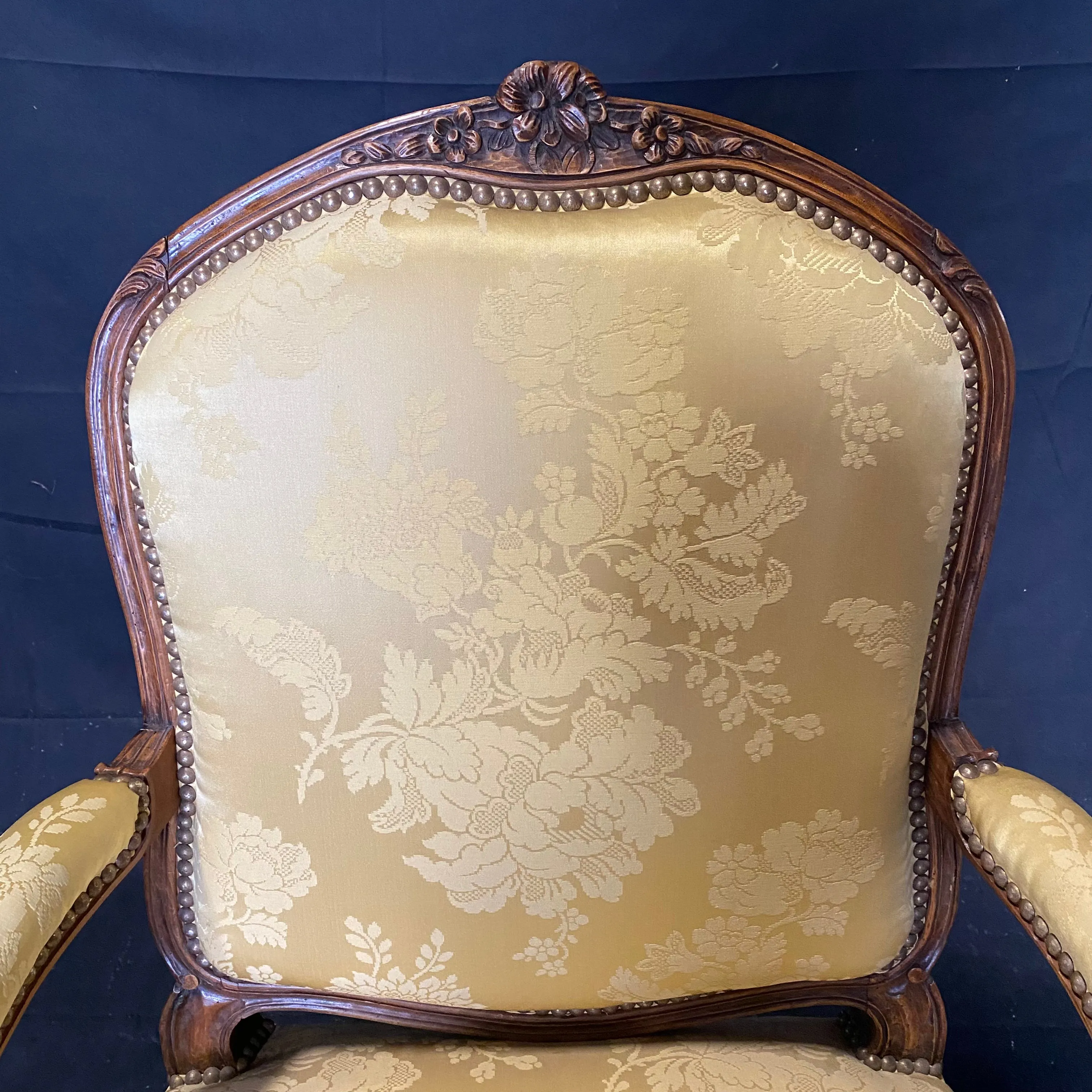 Pair of French Louis XV Walnut Carved Fauteuils or Arm Chairs with Pale Flaxen Yellow Damask and Brass Tacking