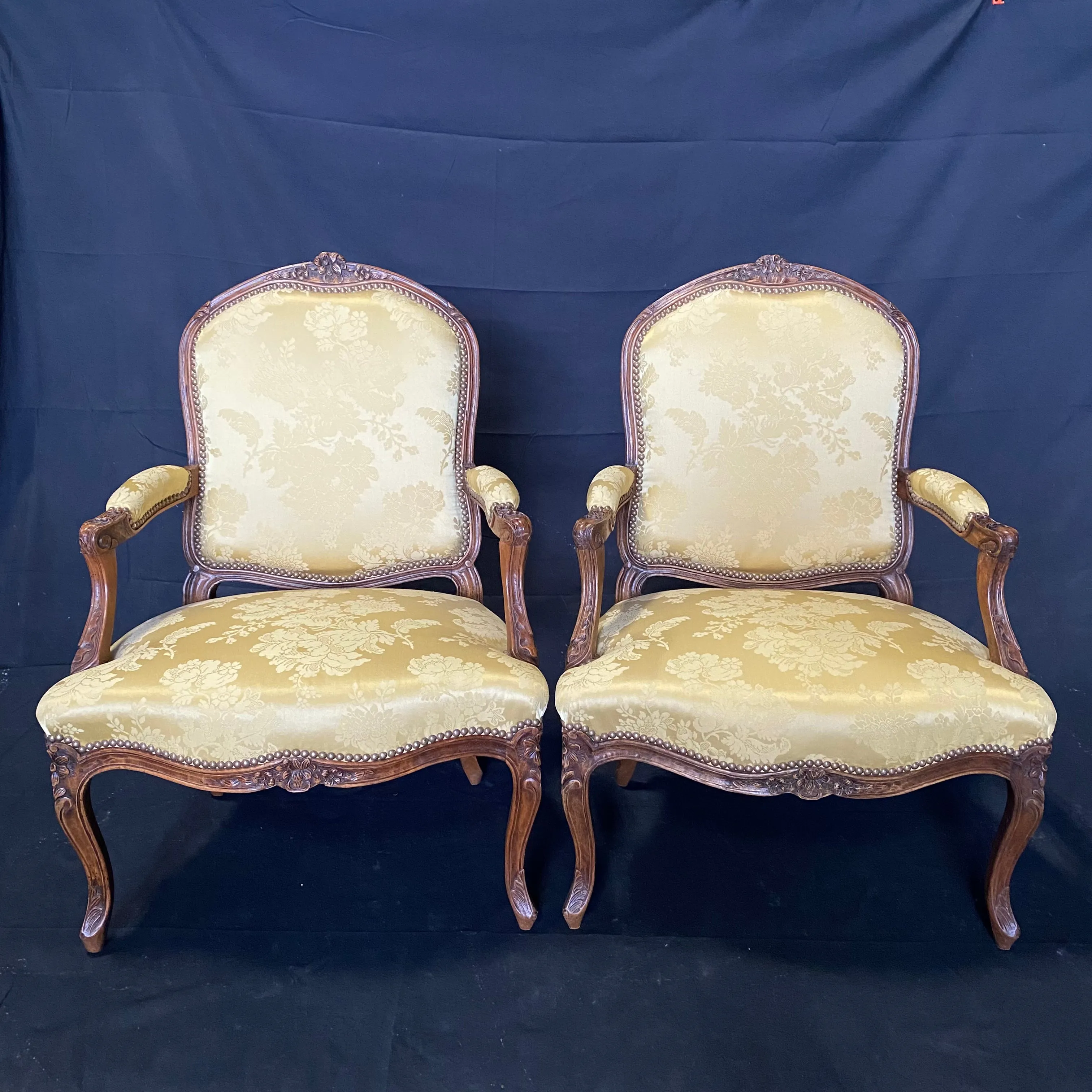 Pair of French Louis XV Walnut Carved Fauteuils or Arm Chairs with Pale Flaxen Yellow Damask and Brass Tacking