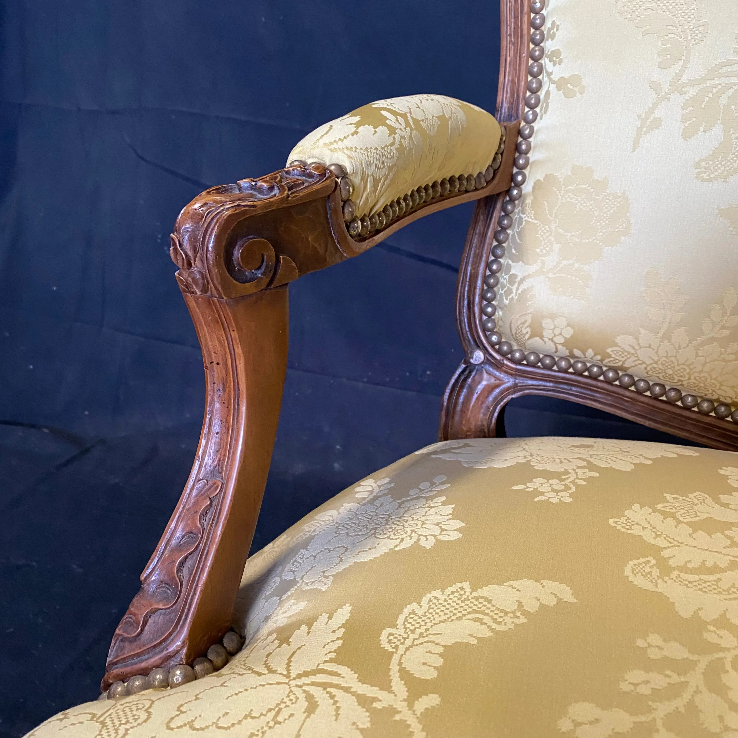 Pair of French Louis XV Walnut Carved Fauteuils or Arm Chairs with Pale Flaxen Yellow Damask and Brass Tacking