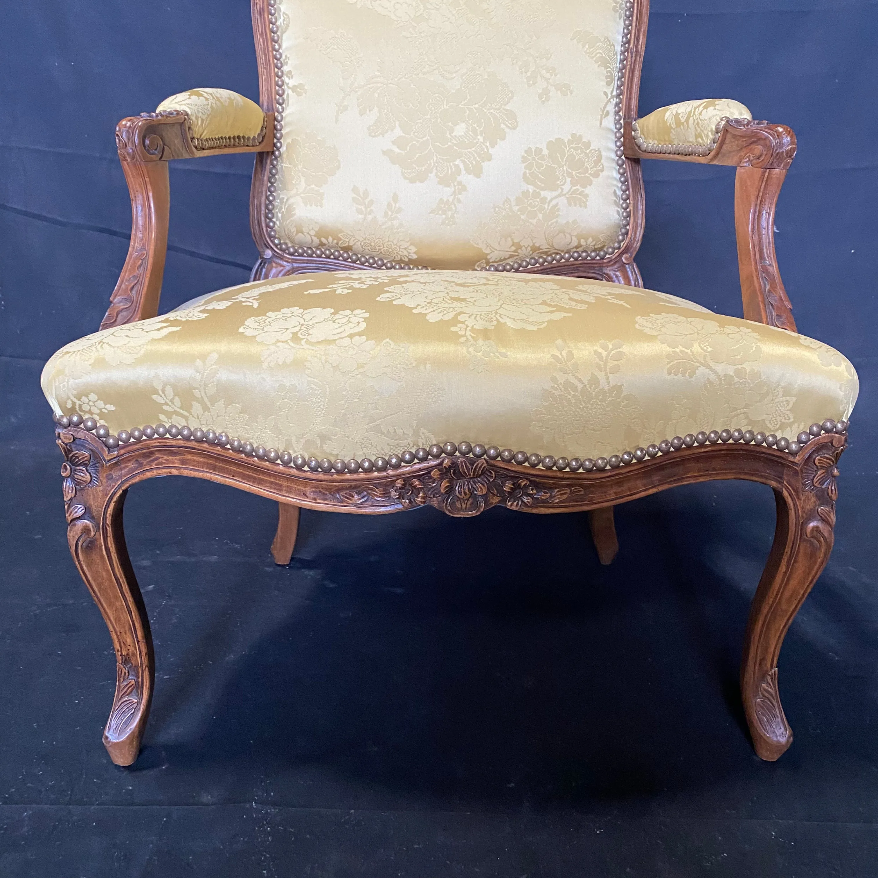 Pair of French Louis XV Walnut Carved Fauteuils or Arm Chairs with Pale Flaxen Yellow Damask and Brass Tacking