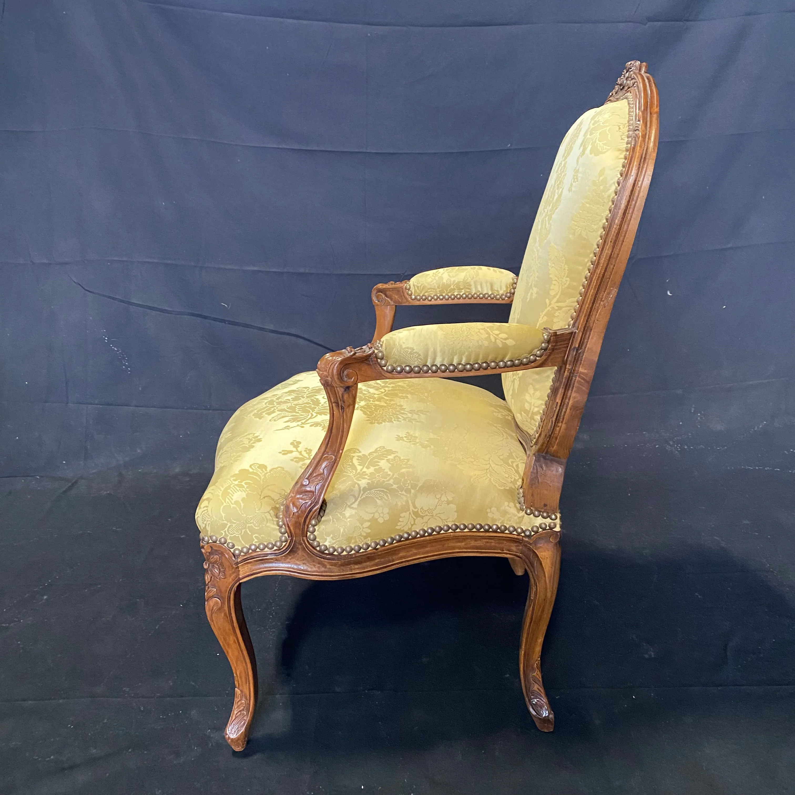 Pair of French Louis XV Walnut Carved Fauteuils or Arm Chairs with Pale Flaxen Yellow Damask and Brass Tacking